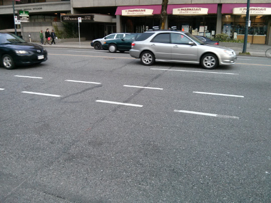 Surface Inlaid Fiber crossing Burrard St., darker line in centre of photo is concrete saw cut